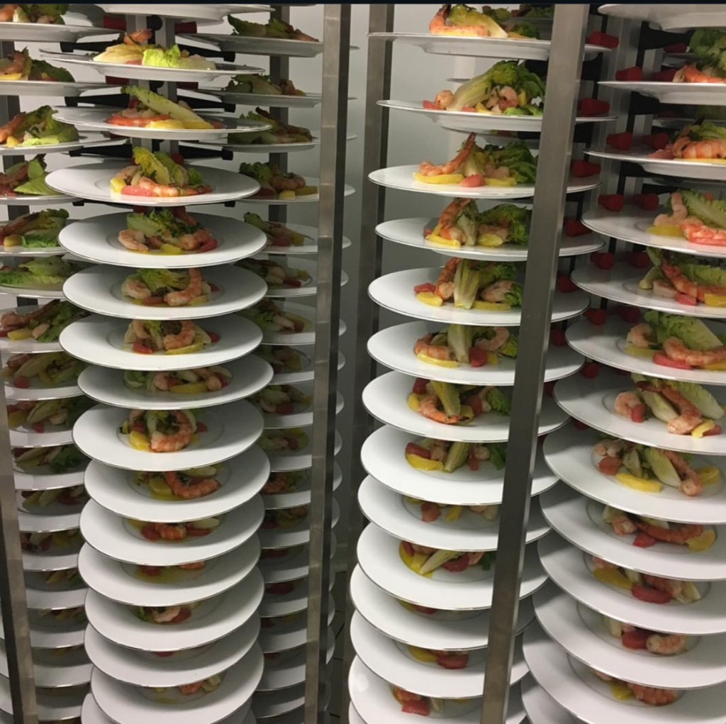 Rows of plated catering meals prepared for event service