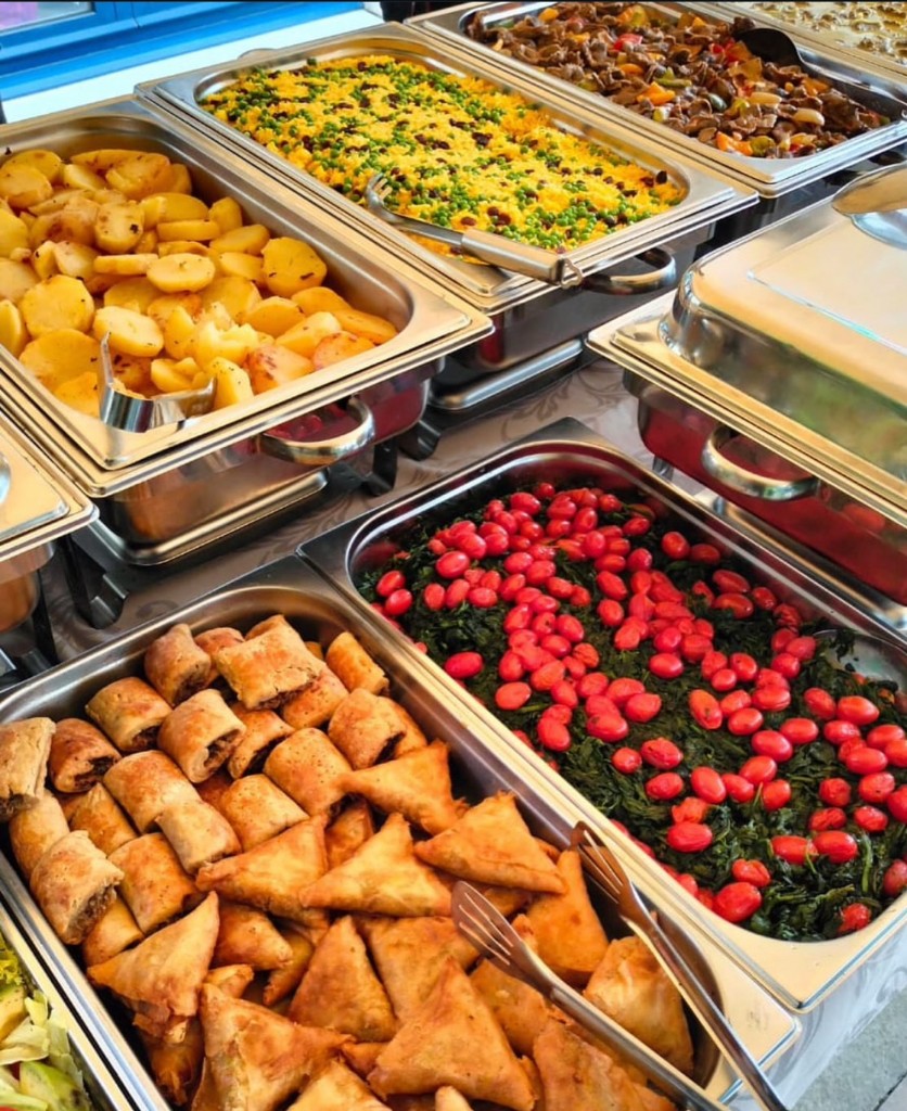 Catering buffet with hot dishes and pastries