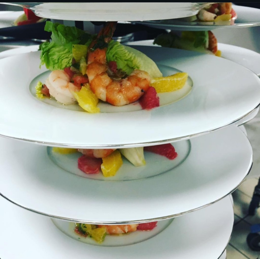 Plated seafood appetizers on stacked racks
